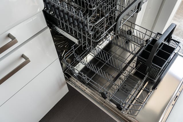 An open, clean-looking dishwasher